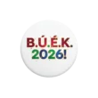 B.Ú.É.K. 2026! szilveszteri kitűző fehér háttér előtt fotózva.